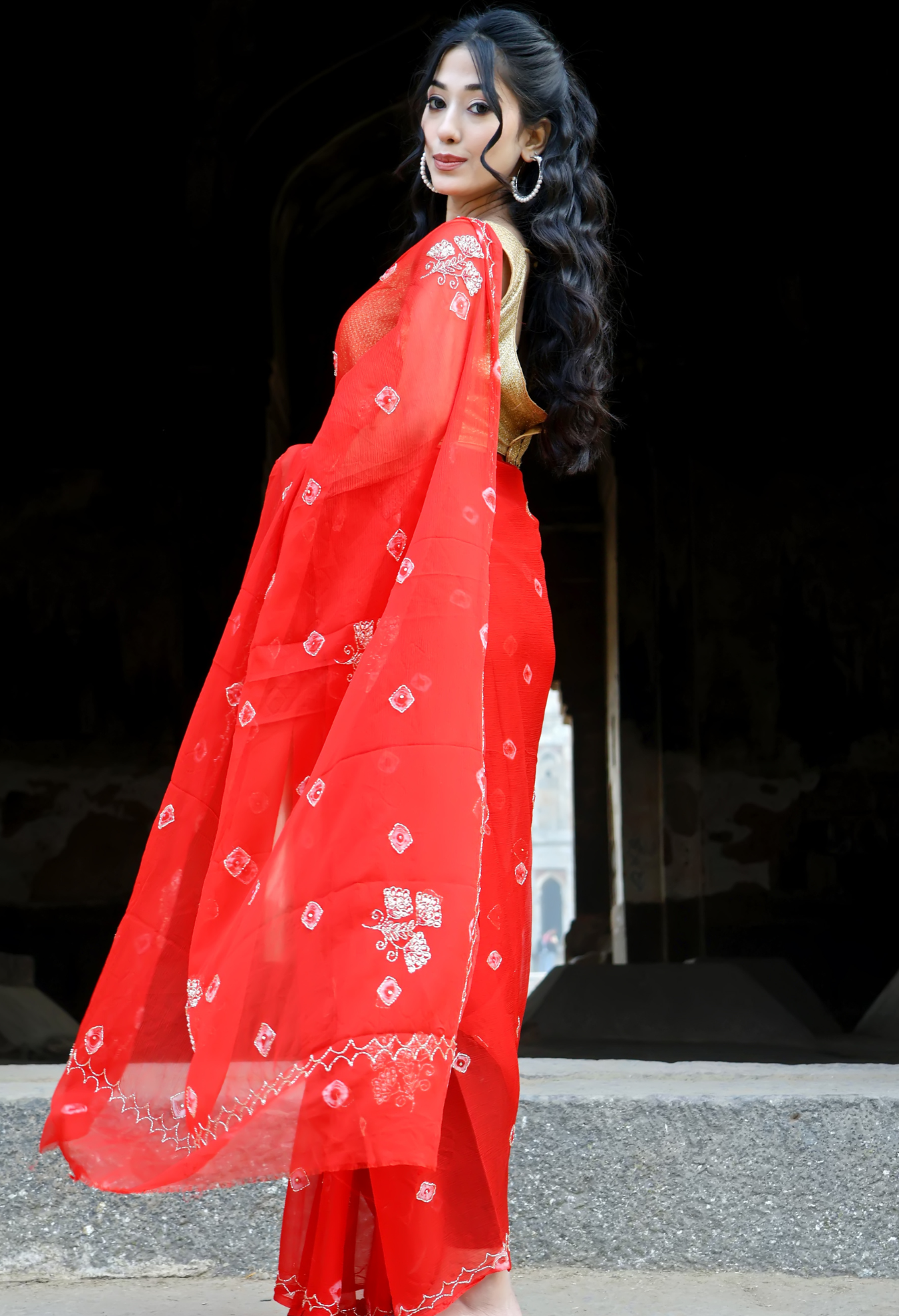 Crimson Red Bandhini saree styled as festive wear, daily wear saree, and party wear saree, a versatile trousseau saree for weddings.