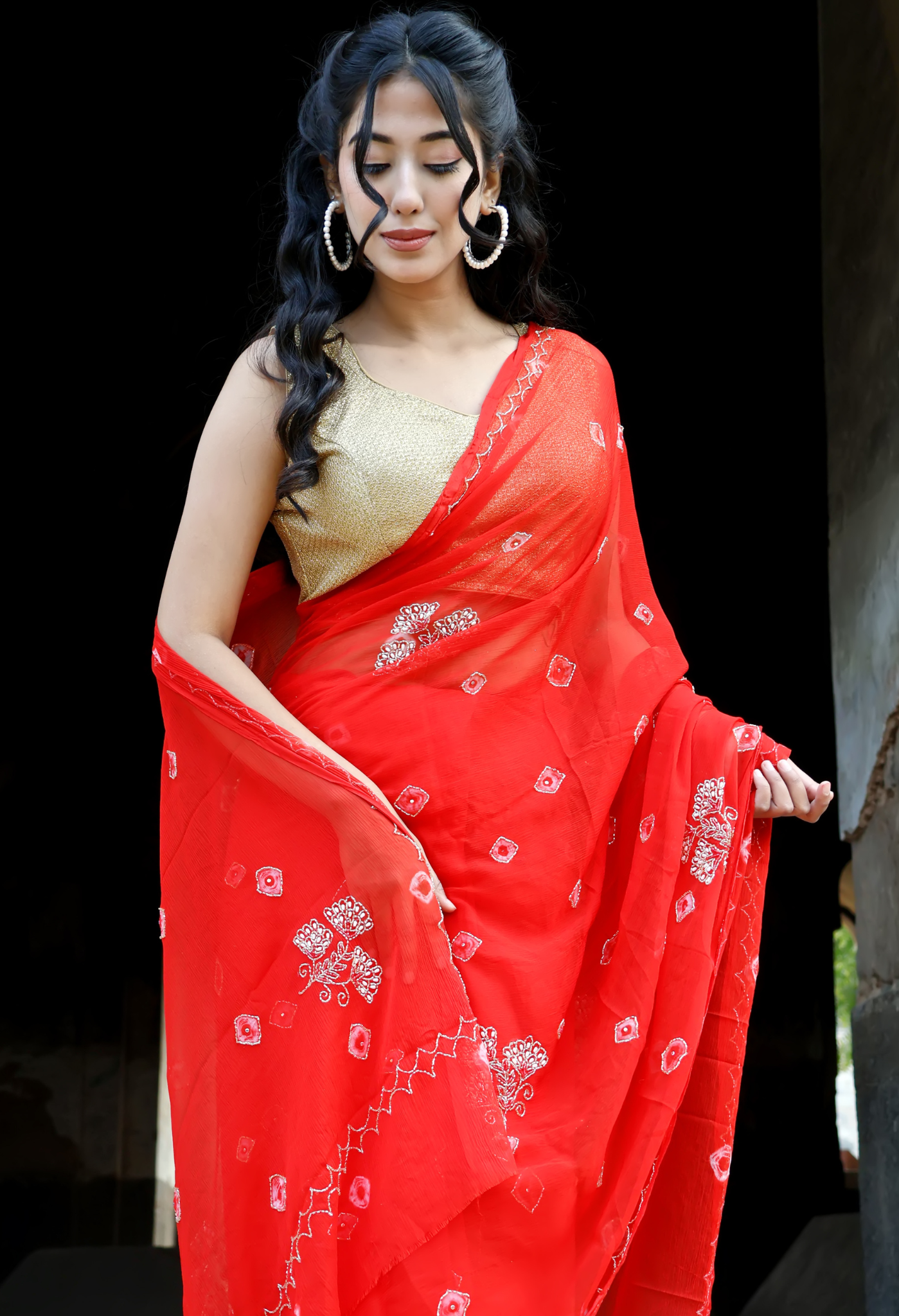 Crimson Red Bandhini saree styled as festive wear, daily wear saree, and party wear saree, a versatile trousseau saree for weddings.