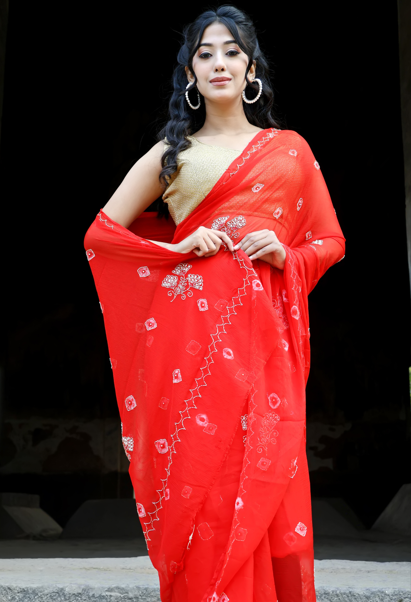 Crimson Red Bandhini saree styled as festive wear, daily wear saree, and party wear saree, a versatile trousseau saree for weddings.