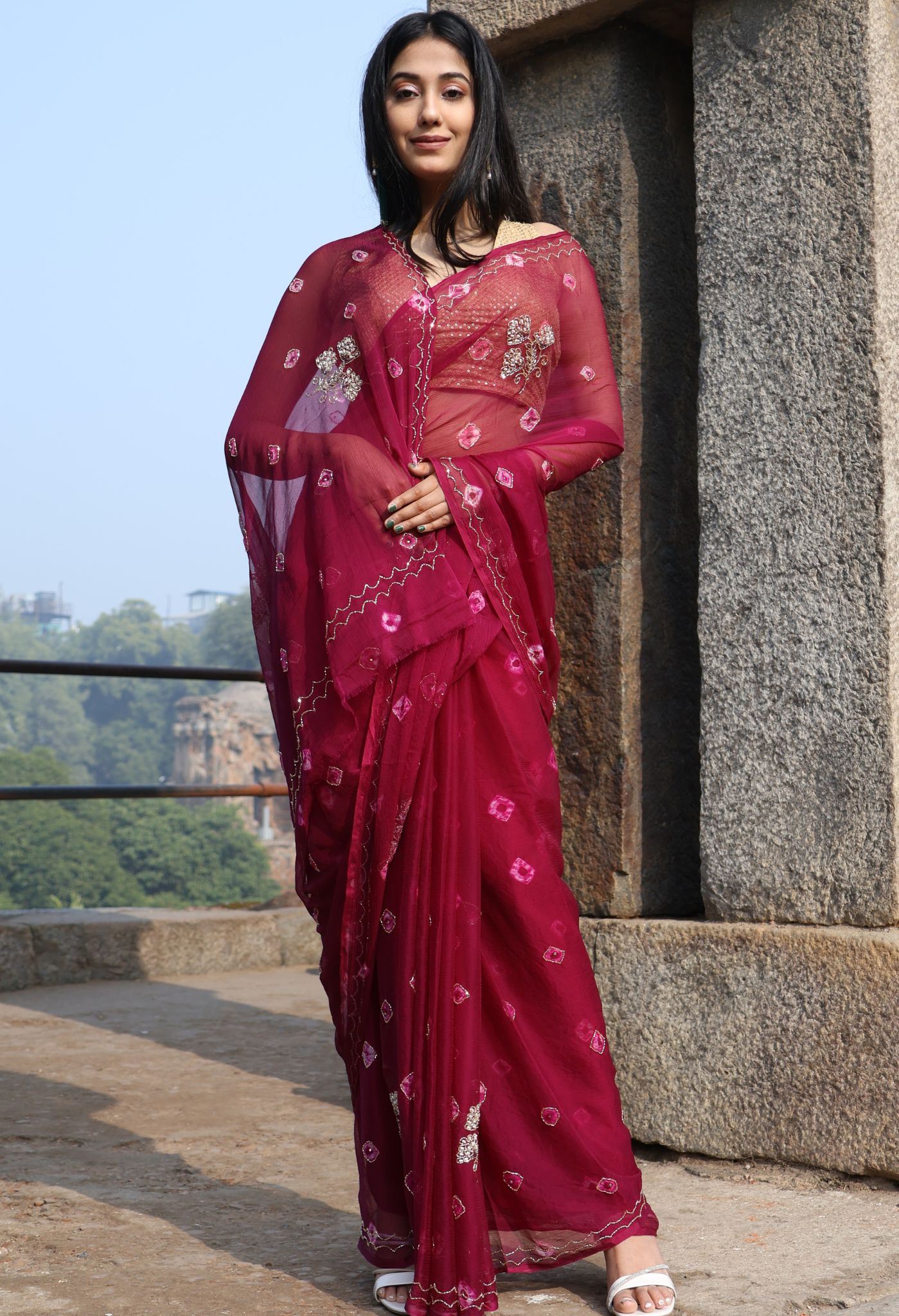 Burgundy Bandhini Embellished chiffon leheriya saree for festive wear, trousseau saree, or farewell saree for timeless pre-wedding collection looks.