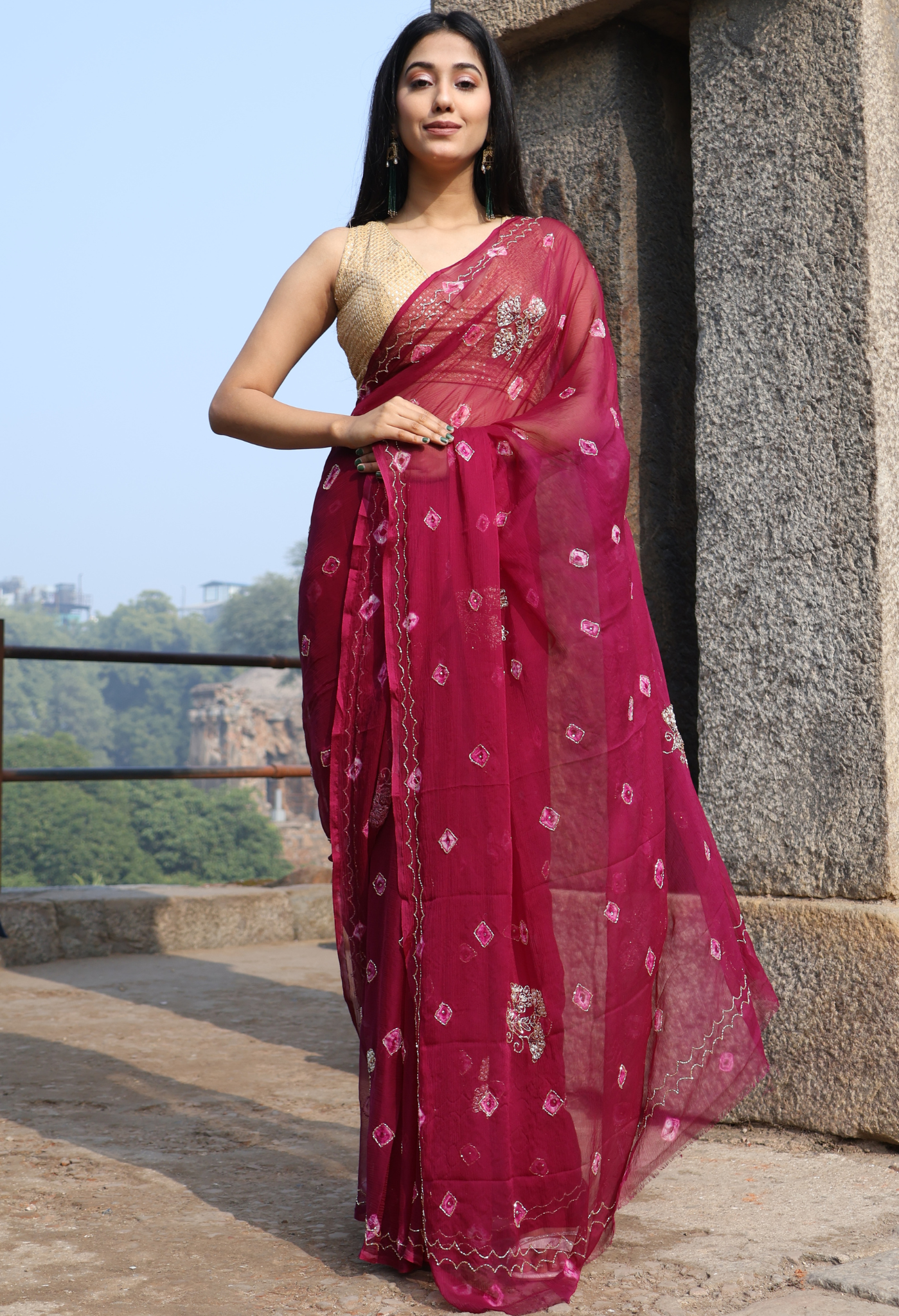 Burgundy Bandhini Embellished chiffon leheriya saree for festive wear, trousseau saree, or farewell saree for timeless pre-wedding collection looks.