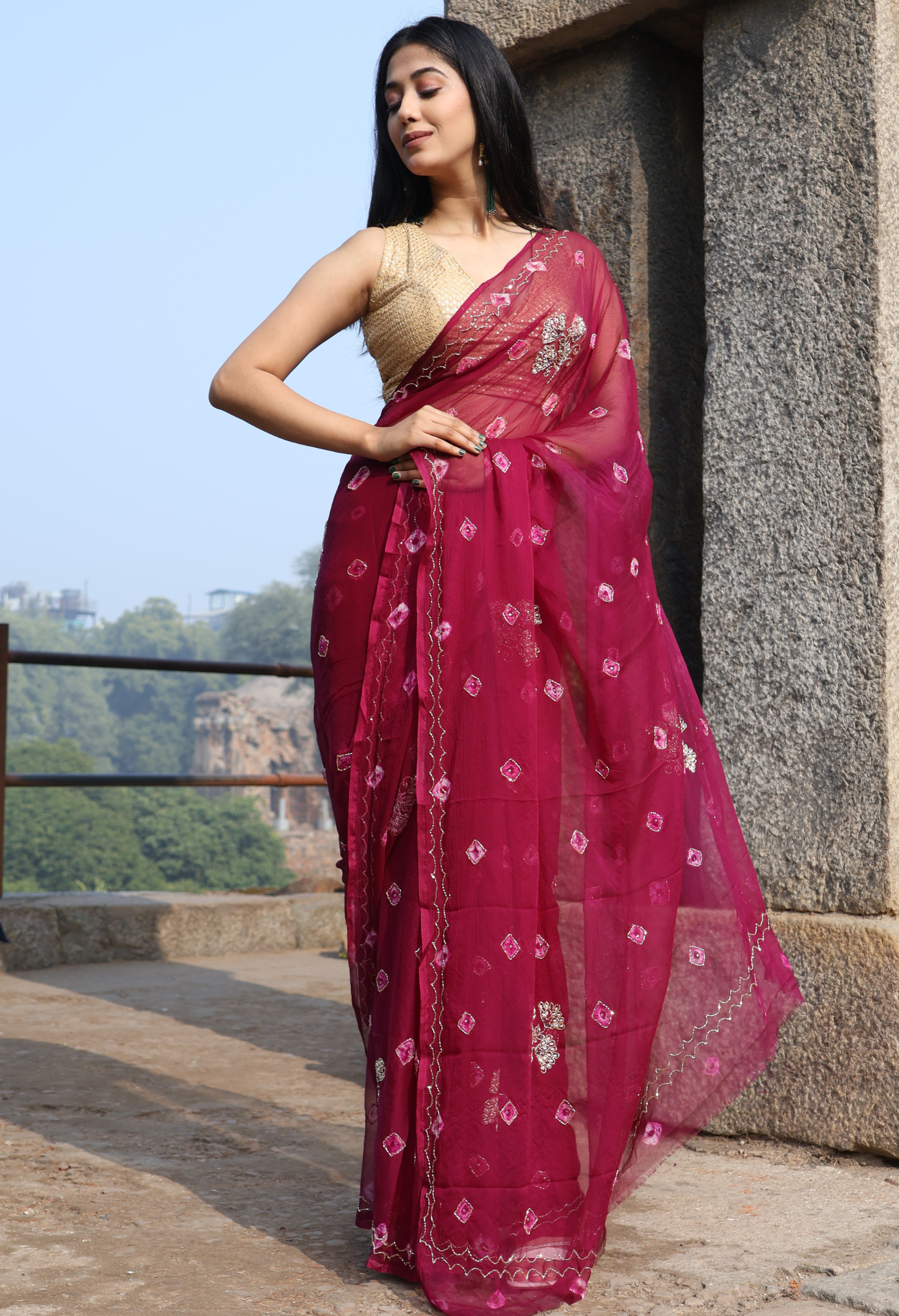 Burgundy Bandhini Embellished chiffon leheriya saree for festive wear, trousseau saree, or farewell saree for timeless pre-wedding collection looks.
